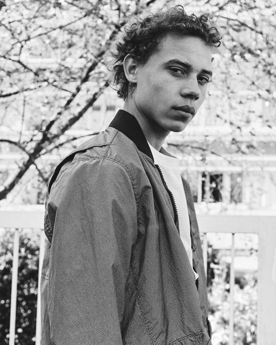 Lye wears jacket Stone Island, t-shirt Kenzo.