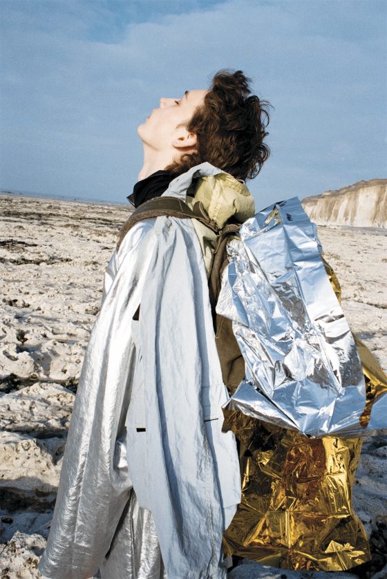 Jacket by Stone Island, tunic by Dries Van Noten, polo shirt by Kenzo.