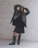 Coat & jumper by Prada kilt by Jordan Luca boots by Underground rings archive