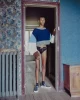 Nolan wears pullover by LOEWE, simsuit by MIU MIU shoes by CELINE HOMME, socks by FALKE