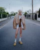 Nikita wears jacket by EGONLAB, shirt & bodysuit by DRIES VAN NOTEN, shoes by CAMPER, socks by AMERICAN APPAREL.