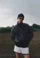 Elias wears jacket by AMBUSH, short by LACOSTE, hat by GIVENCHY, sunglasses by CHIMI