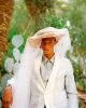 Jacket & shirt by Dior, hat & veil by Ann Demeulemeester