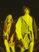 Rosalieke wears coat by Dries Van Noten, sweater by Isabel Marant, trousers by Joseph, necklace by Chloé, brooch by Louis Vuitton Mustafa wears jacket & trousers by JW Anderson, shirt by Prada
