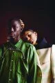 Khadim wears shirt by Comme des Garçons Homme Plus, necklace by Y/Project. Annibelis wears coat by Prada, earrings by Vivenne Westwood