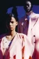 Annibelis wears jacket by Facetasm, dress by Miu Miu, earring by Garnazelle. Khadim wears coat & turtleneck by Ann Demeulemeester, jacket by Facetasm