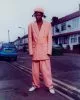 Brian wears jacket & trousers by Paul Smith, shoes by Lacoste, hat by Kangol, jewellery from stylist’s archive