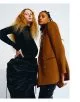 Tya wears turtleneck by Patou jacket colar by Raf Simons skirt by Y/Project. Allexa wears all clothes by Saint Laurent by Anthony Vaccarello