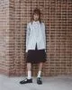 Jumper by Acne Studios, skirt by National Theatre Costume Hire, sunglasses by Balenciaga, belt by Underground, socks by Pantherella, shoes by Saint Laurent by Anthony Vaccarello