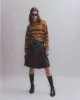 Jumper by Acne Studios,skirt by National Theatre Costume Hire, sunglasses by Balenciaga, belt by Underground, socks by Pantherella, shoes by Saint Laurent by Anthony Vaccarello