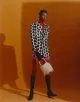 Jacket by Gucci, turtleneck by Bianca Saunders, boxer shorts by Louis Gabriel Nouchi, necklace & gloves by Givenchy, bag by Jacquemus, tights by Falke, boots by Saint Laurent by Anthony Vaccarello