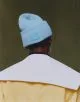 Coat by Jacquemus, hat by Acne Studios, earring by Louis Vuitton