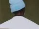 Coat by Jacquemus, hat by Acne Studios, earring by Louis Vuitton